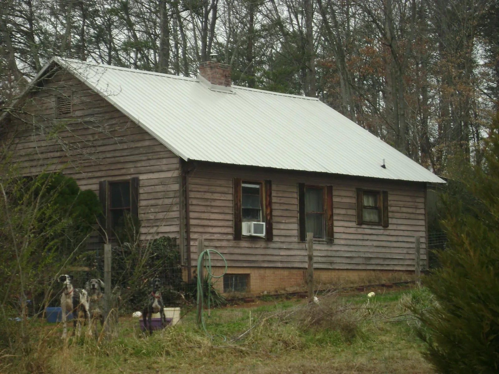 White metal roof on an old wood sided farmhouse, from a Metal Roof Installation job in Centerville